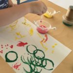 Child engaging in painting at daycare